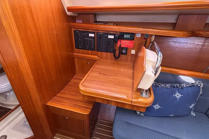 Slide: The Image of 2006 Hunter 38 yacht interior with navigation station and wooden finish. - 39