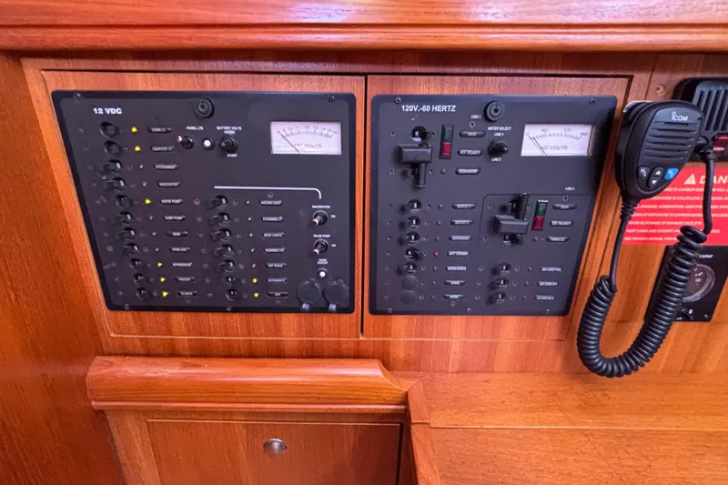 Slide: The Image of Electrical control panel on a 2006 Hunter 38 sailboat, featuring 12V and 120V systems. - 40