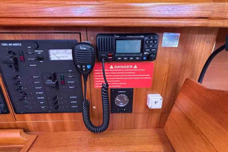 Slide: The Image of Control panel of a 2006 Hunter 38 sailboat with radio and warning sign. - 41