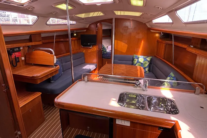 Slide: The Image of Interior of 2006 Hunter 38 sailboat with wood finish and cozy seating area. - 43