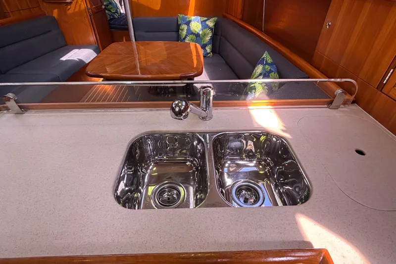 Slide: The Image of Interior of 2006 Hunter 38 yacht with dual sink and cozy seating area. - 44