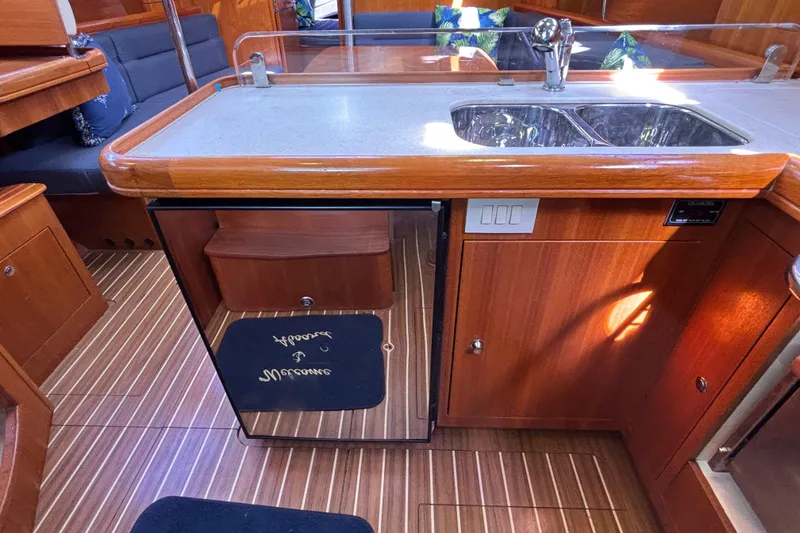 Slide: The Image of Interior of 2006 Hunter 38 sailboat kitchen with wood finish and dual sink. - 48