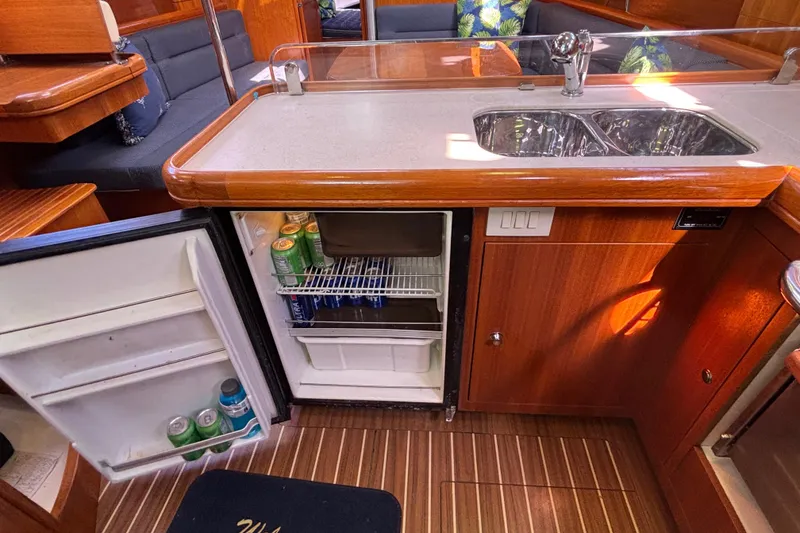 Slide: The Image of Interior of 2006 Hunter 38 yacht with open fridge and dual sink. - 49