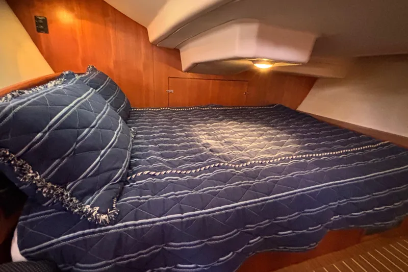 Slide: The Image of Cozy cabin interior of 2006 Hunter 38 sailboat with blue quilted bedding. - 53