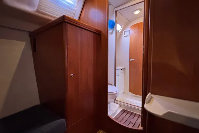 Slide: The Image of Interior of 2006 Hunter 38 yacht showing bathroom and wooden cabinetry. - 57