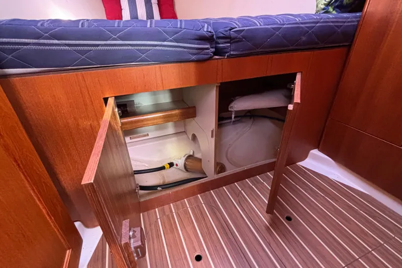 Slide: The Image of Interior of 2006 Hunter 38 sailboat showing open storage compartment under bed. - 61
