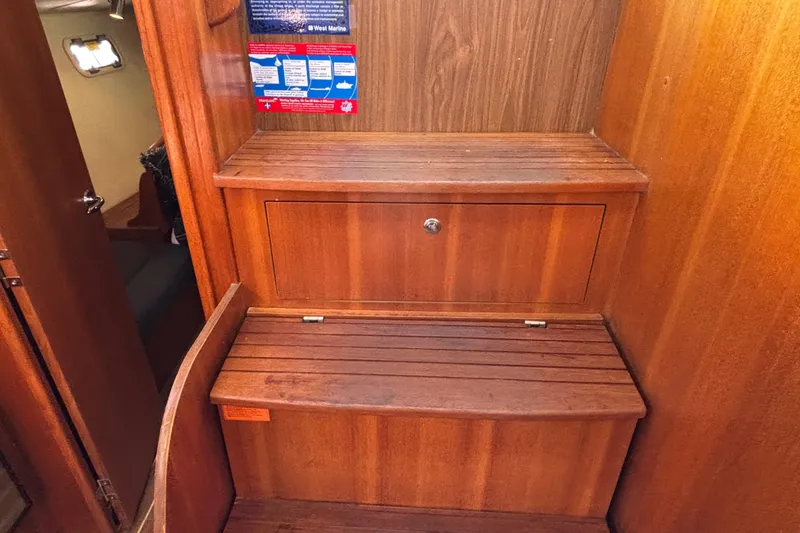 Slide: The Image of Wooden interior of a 2006 Hunter 38 sailboat with storage compartment. - 64
