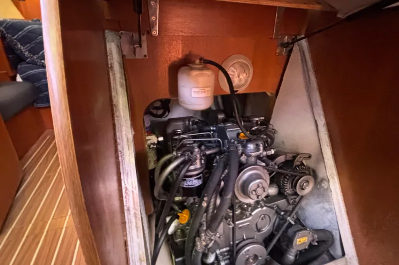 Slide: The Image of Engine compartment of a 2006 Hunter 38 sailboat, showcasing mechanical components and interior design. - 66