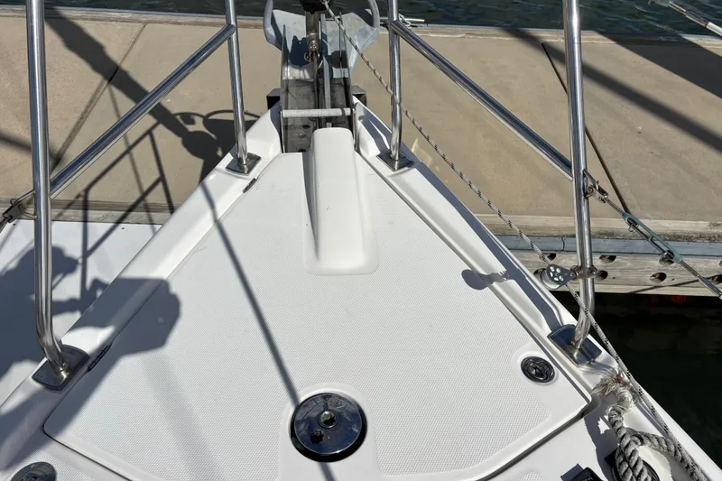 Slide: The Image of Bow of a 2006 Hunter 38 sailboat docked at a marina. - 7