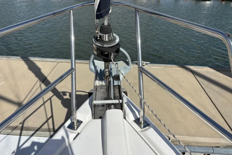 Slide: The Image of Bow of 2006 Hunter 38 sailboat docked, featuring anchor and railing. - 8