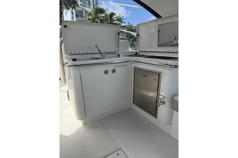 Slide: The Image of 2015 Sea Ray 370 Venture boat kitchenette with sink and storage. - 14