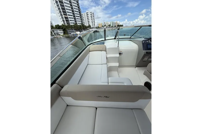 Slide: The Image of 2015 Sea Ray 370 Venture boat interior with plush seating and waterfront view. - 17