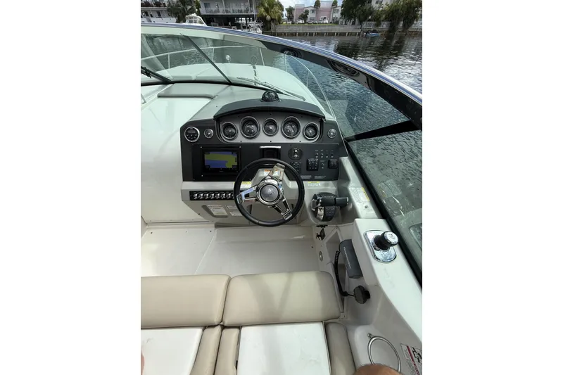 Slide: The Image of 2015 Sea Ray 370 Venture boat cockpit with steering wheel and control panel. - 19