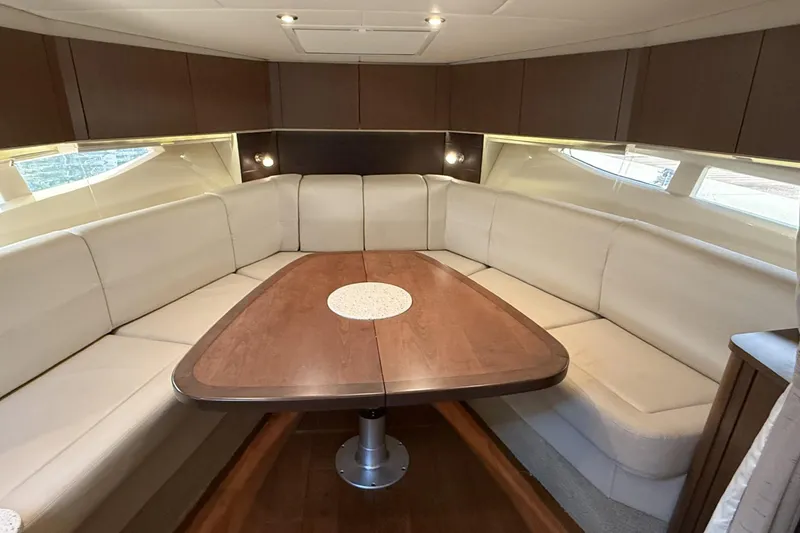 Slide: The Image of Luxurious interior of 2015 Sea Ray 370 Venture yacht with elegant seating and wooden table. - 22