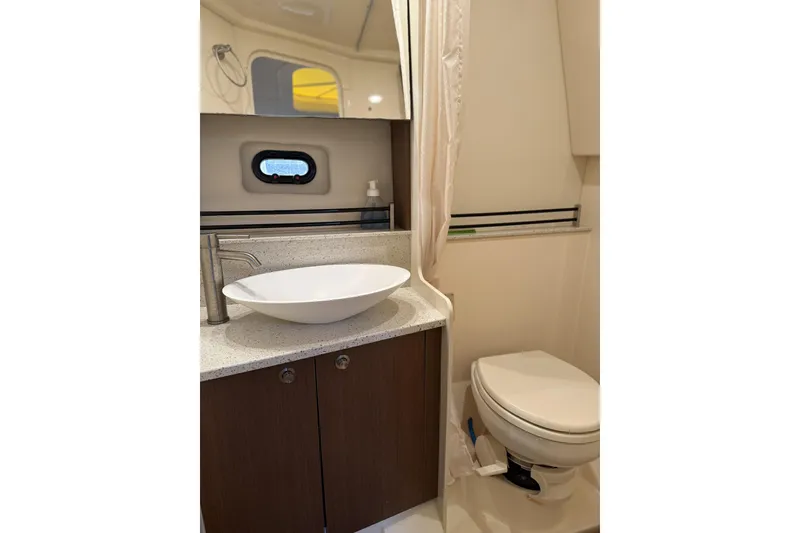 Slide: The Image of 2015 Sea Ray 370 Venture bathroom with modern sink and toilet. - 27