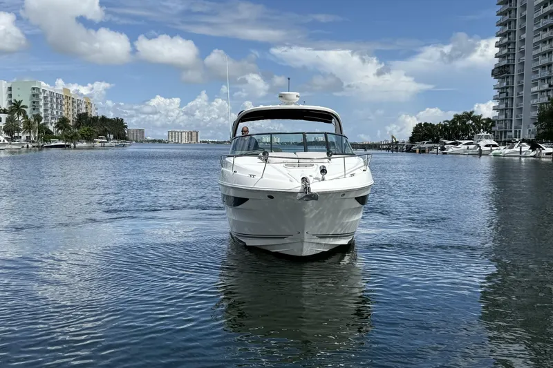 Slide: The Image of 2015 Sea Ray 370 Venture yacht cruising in a scenic waterfront setting. - 3