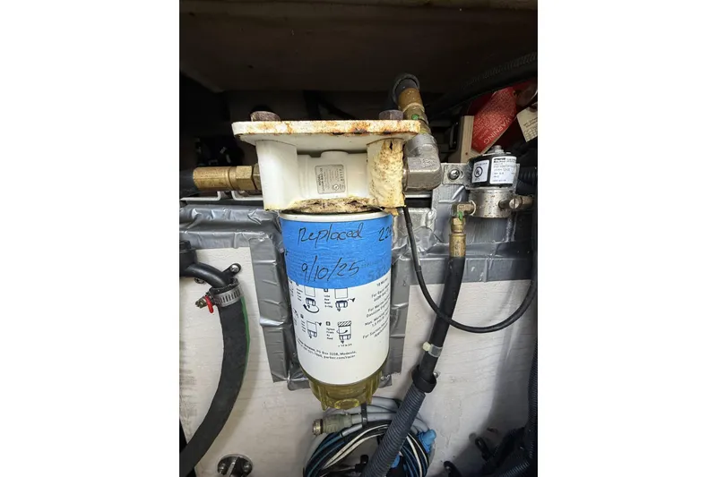 Slide: The Image of Fuel filter system in a 2015 Sea Ray 370 Venture boat, labeled with replacement date. - 30