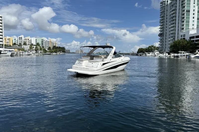 Slide: The Image of 2015 Sea Ray 370 Venture yacht cruising in a scenic urban marina. - 9
