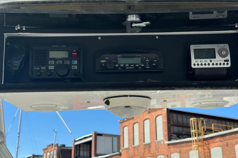 Slide: The Image of 1990 Donzi F 33 boat dashboard with communication and audio equipment. - 11