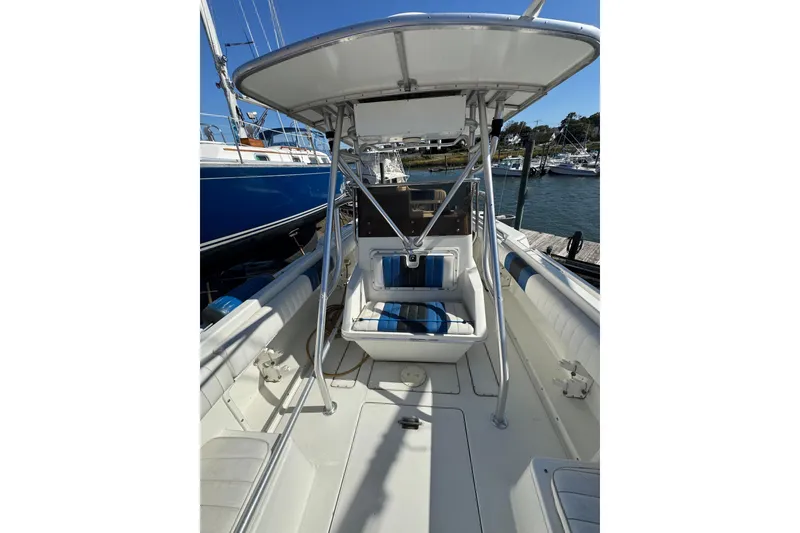 Slide: The Image of 1990 Donzi F 33 boat interior with seating and canopy at a marina. - 13