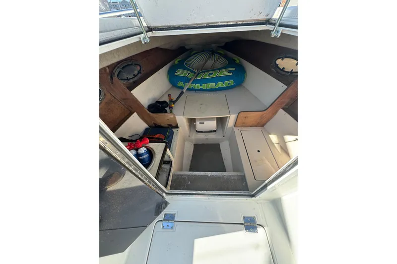 Slide: The Image of 1990 Donzi F 33 boat interior with storage and inflatable water toy. - 15