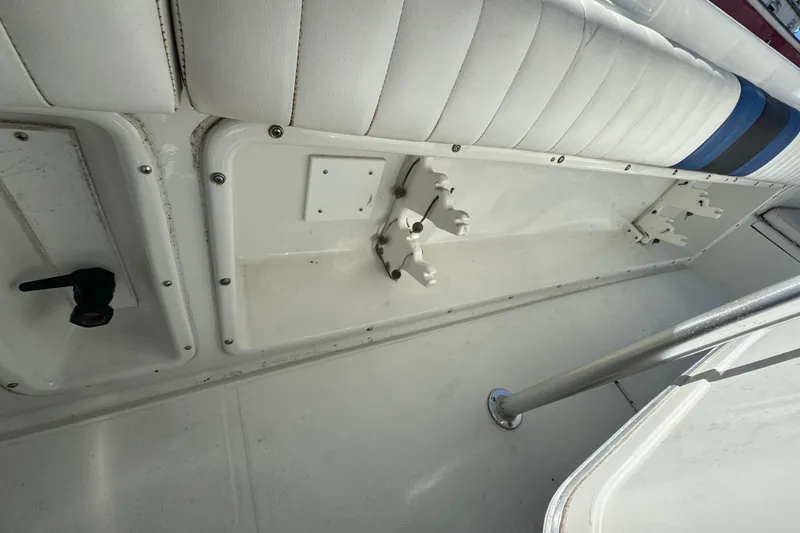 Slide: The Image of Interior view of a 1990 Donzi F 33 boat, featuring white seating and storage compartments. - 16