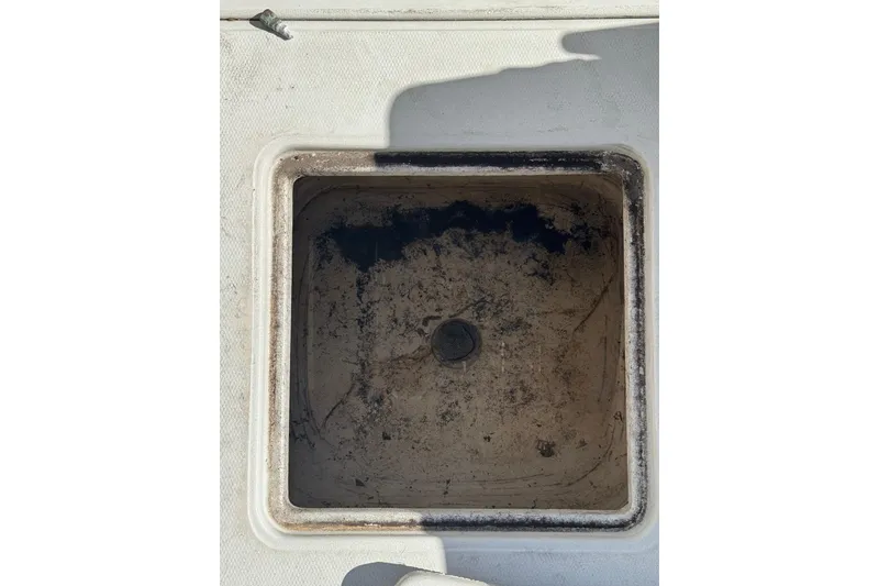 Slide: The Image of Storage compartment of a 1990 Donzi F 33 boat, showing wear and dirt. - 19