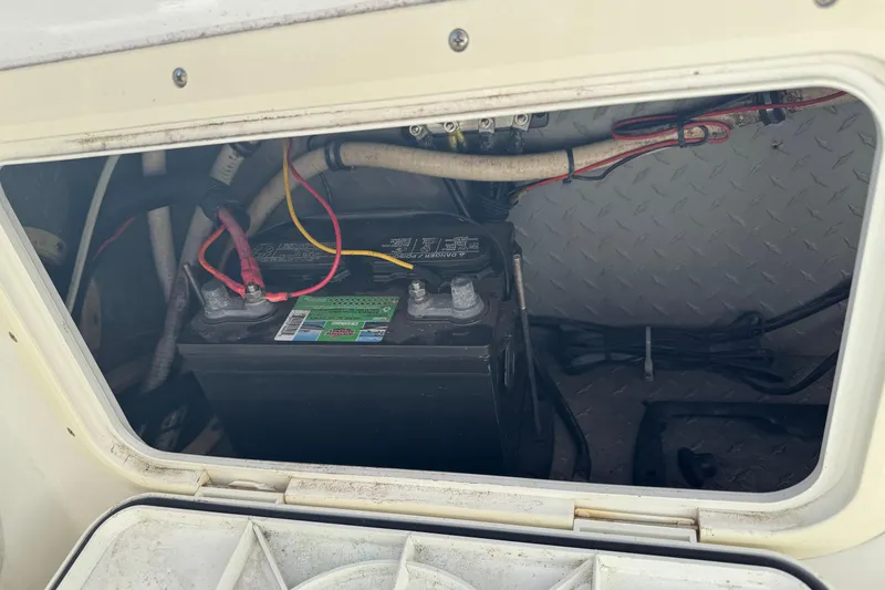 Slide: The Image of Battery compartment of a 1990 Donzi F 33 boat, showing wiring and connections. - 22