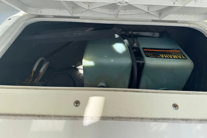 Slide: The Image of 1990 Donzi F 33 boat compartment with Yamaha oil tank visible. - 24