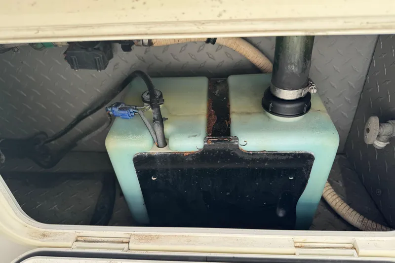 Slide: The Image of 1990 Donzi F 33 boat fuel tank with connected hoses and fittings. - 25