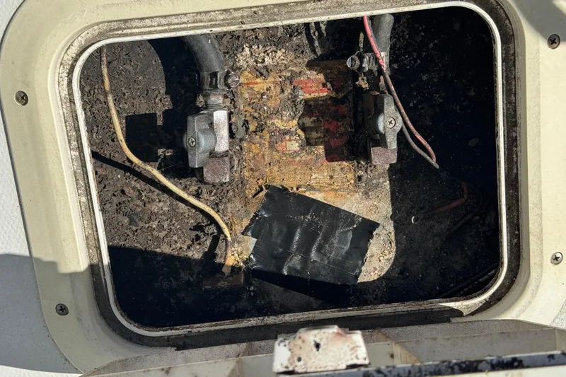 Slide: The Image of Dirty engine compartment of a 1990 Donzi F 33 boat with visible wiring. - 26