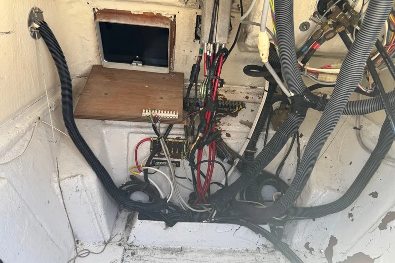 Slide: The Image of Wiring and components inside a 1990 Donzi F 33 boat, showcasing electrical setup. - 27