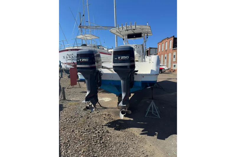 Slide: The Image of 1990 Donzi F 33 boat with twin V250 outboard engines on dry dock. - 5