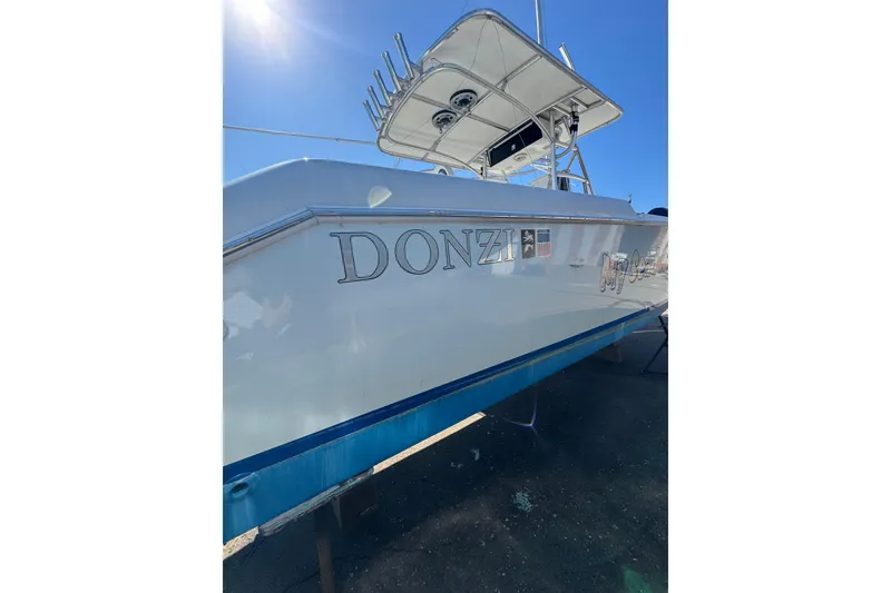 Slide: The Image of 1990 Donzi F 33 boat with sleek design under clear blue sky. - 8