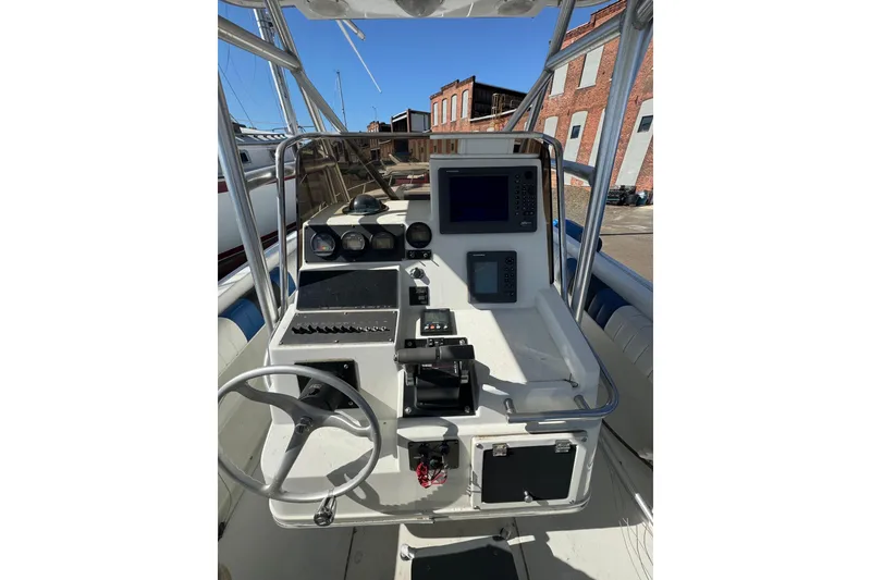 Slide: The Image of 1990 Donzi F 33 boat dashboard with steering wheel and navigation instruments. - 9