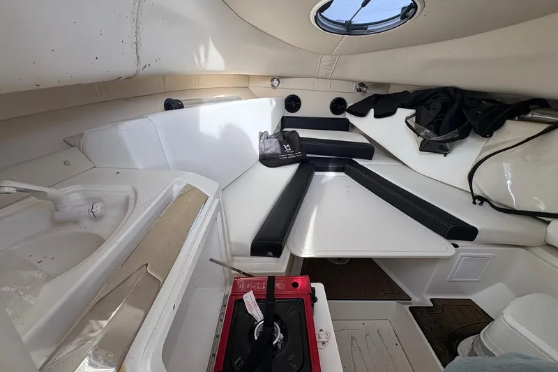Slide: The Image of 2018 Striper 230 Walkaround cabin interior with seating, sink, and storage. - 15