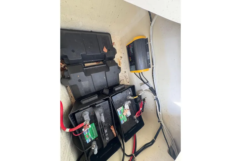 Slide: The Image of Battery compartment of 2018 Striper 230 Walkaround boat with wiring and charger. - 17