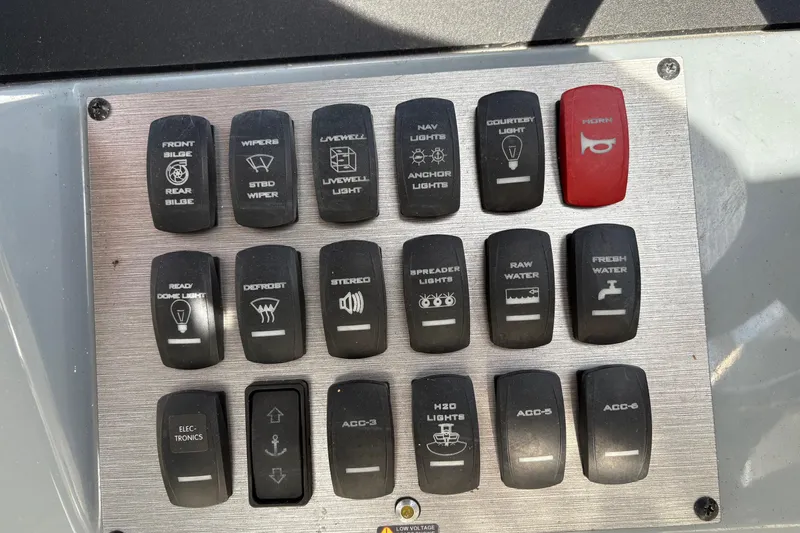 Slide: The Image of Control panel of a 2018 Striper 230 Walkaround boat with labeled switches. - 19