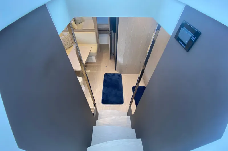 Slide: The Image of Interior view of 2021 Azimut Atlantis 45 yacht, featuring modern staircase and cozy seating area. - 36