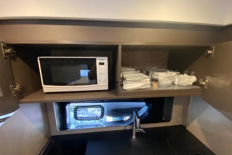 Slide: The Image of Modern kitchen in 2021 Azimut Atlantis 45 yacht with microwave and dish storage. - 41