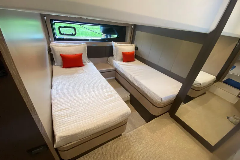 Slide: The Image of Twin cabin interior of 2021 Azimut Atlantis 45 yacht with modern decor and orange accents. - 48