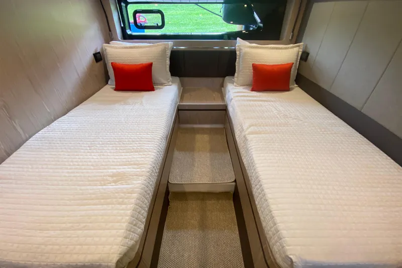Slide: The Image of Twin beds with white bedding and orange pillows in 2021 Azimut Atlantis 45 yacht cabin. - 49