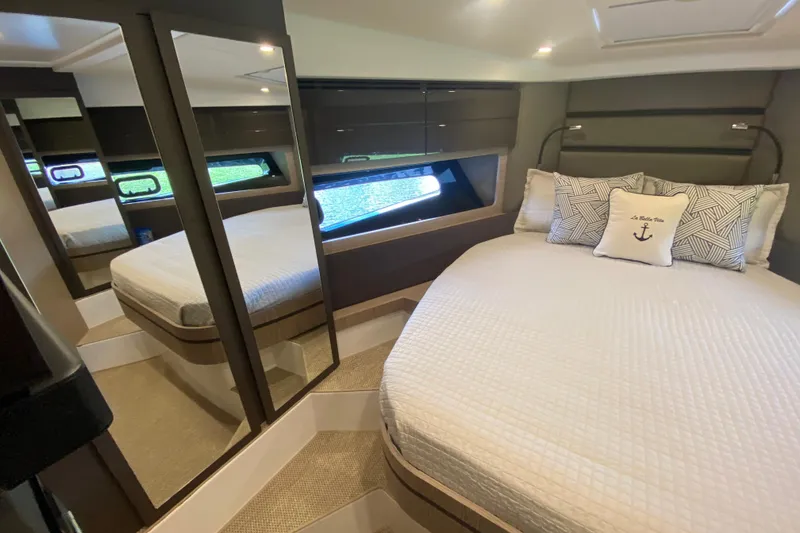 Slide: The Image of Luxurious bedroom interior of 2021 Azimut Atlantis 45 yacht with elegant bedding and mirrored closet. - 54