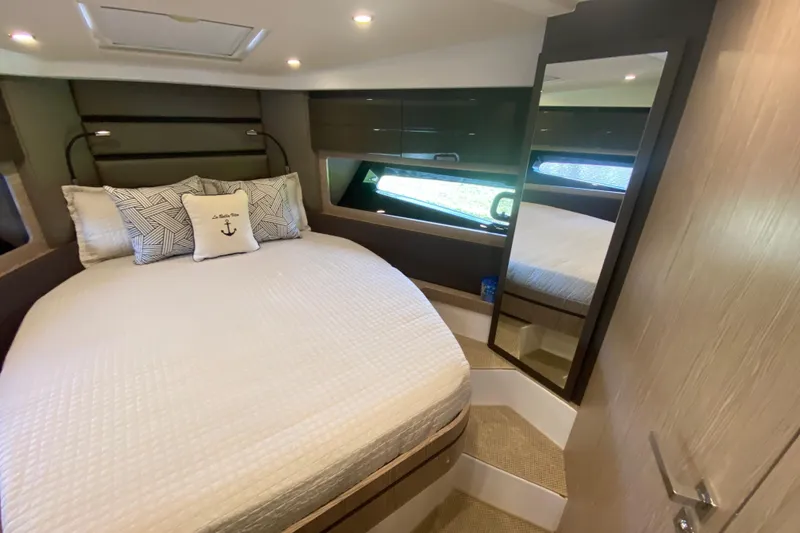 Slide: The Image of Luxurious bedroom interior of 2021 Azimut Atlantis 45 yacht with elegant bedding and mirror. - 55