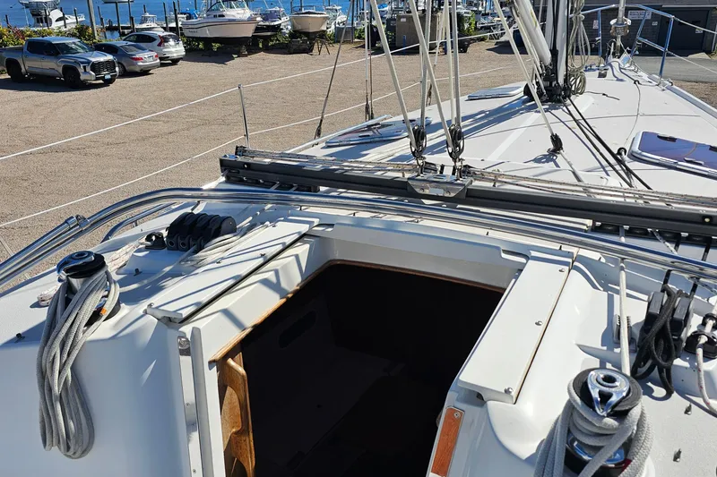 Slide: The Image of 2007 Catalina 350 sailboat deck with ropes and winches, docked near other boats. - 10