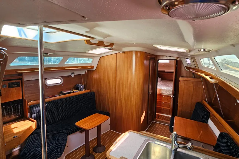 Slide: The Image of Interior of 2007 Catalina 350 sailboat with wood finish and seating area. - 14