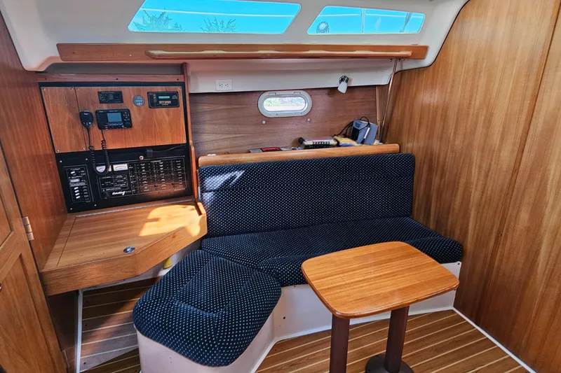 Slide: The Image of Interior of a 2007 Catalina 350 sailboat with wood paneling and navigation equipment. - 16
