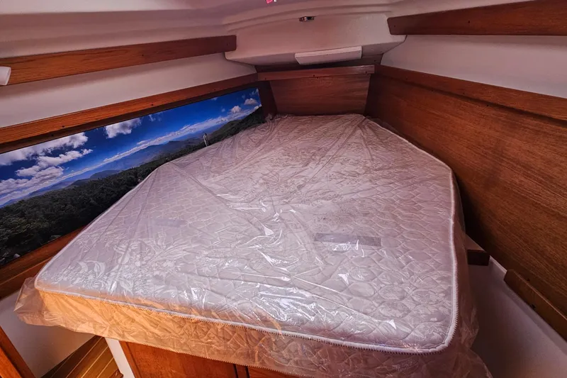 Slide: The Image of Interior cabin of 2007 Catalina 350 sailboat with mattress and scenic wall art. - 20