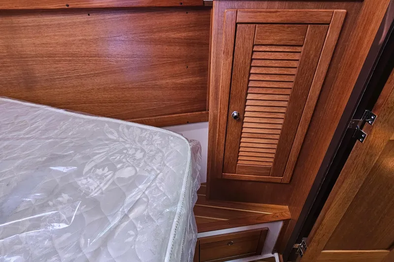 Slide: The Image of Interior of 2007 Catalina 350 sailboat with wooden cabinetry and mattress. - 22
