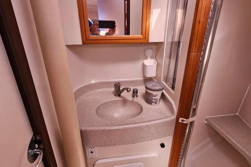 Slide: The Image of Compact bathroom in a 2007 Catalina 350 sailboat, featuring a sink and mirror. - 23